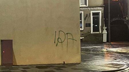 Man arrested after graffiti sprayed near Troubles memorial