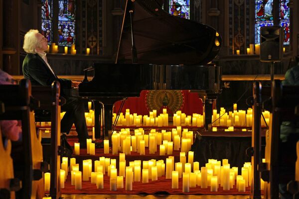 Frank McNamara, playing piano by candlelight. Frank McNamara, playing piano by candlelight.