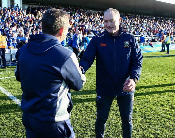 Rival managers Liam Cahill and Davy Fitzgerald shake hands at the end of the game.