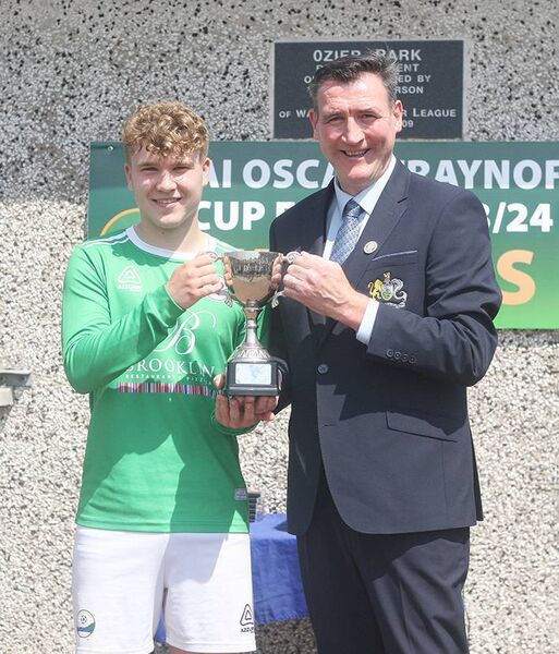 Brendan Rea of the WDJL presents Ferrybank captain Daniel Donnelly with the Ball Corporation Under 17B Cup at Ozier Park on Sunday. Brendan Rea of the WDJL presents Ferrybank captain Daniel Donnelly with the Ball Corporation Under 17B Cup at Ozier Park on Sunday.