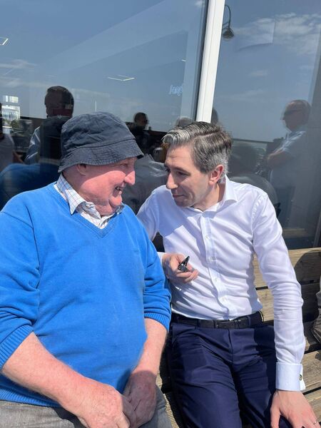 Local Johnny Nolan enjoys the hottest day in Tramore to date this year as he chats with Taoiseach Simon Harris. Local Johnny Nolan enjoys the hottest day in Tramore to date this year as he chats with Taoiseach Simon Harris.
