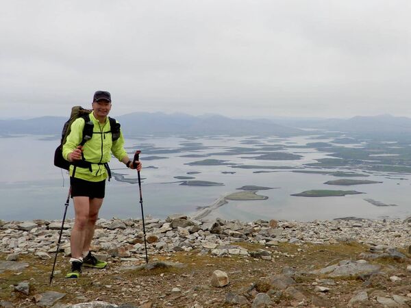 Aidan on Croagh Patrick summit overlooking Clew Bay in Co. Mayo, on day five of his journey to traverse every mountain in Ireland for charity.