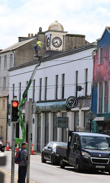 The clock above Martin Barrett Car sales, on Catherine Street, getting a Summer make over. Photo: Joe Evans
