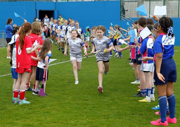 Waterford mascots Lily O'Sullivan and Annabelle Murphy lead out the Waterford team in Walsh Park.