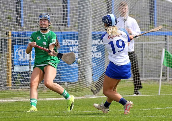 Waterford's Annie Fitzgerald fires her shot past Limerick goalkeeper Clara Mulqueen for her side's fifth goal of the game.
