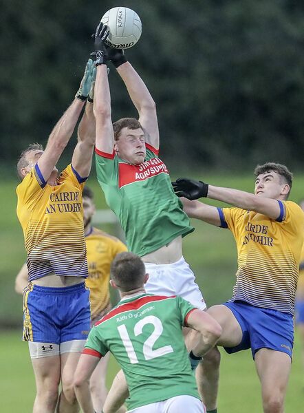 Rathgormack's Michael Curry in an aeriel duel with Nire's James McGrath. These great rivals will meet again on Wednesday night in the Division 1 County Football league final. Photos: Sean Byrne.