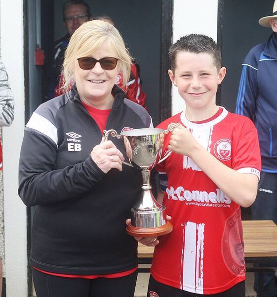 Deirdre Burke presents De La Salle captain Robbie McCarthy with the Eoin Burke U12B Cup at Graun Park. Deirdre Burke presents De La Salle captain Robbie McCarthy with the Eoin Burke U12B Cup at Graun Park.
