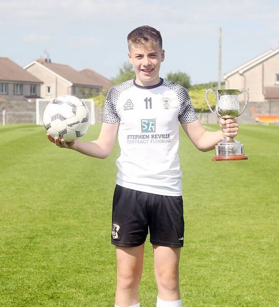Hat Trick hero for Tramore Fionn McCarthy Kelleher with the match ball and the Joe Delaney Cup.