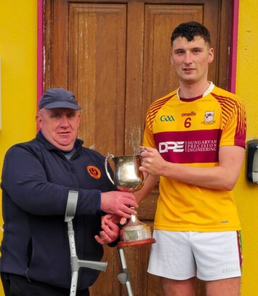 Thomas Keane presenting the Bob Keane Memorial Cup to the Sliabh gCua winning captain, Killian Tobin