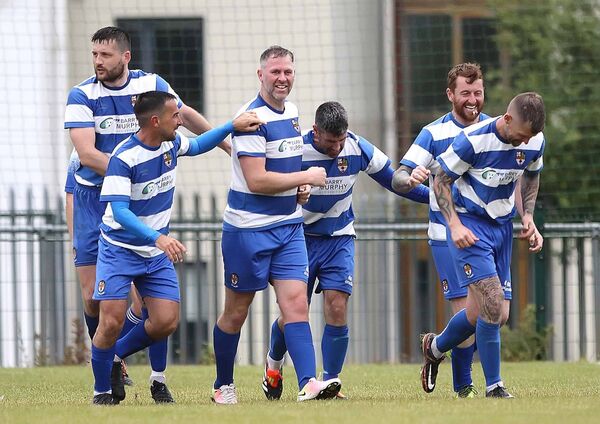 St. Joseph’s Daryl Murphy is surrounded by his team mates after scoring the winning goal.