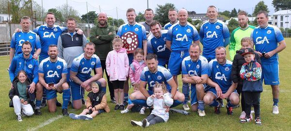 Dungarvan United celebrate after they were presented with the trophy for winning this year's Div.4 league.