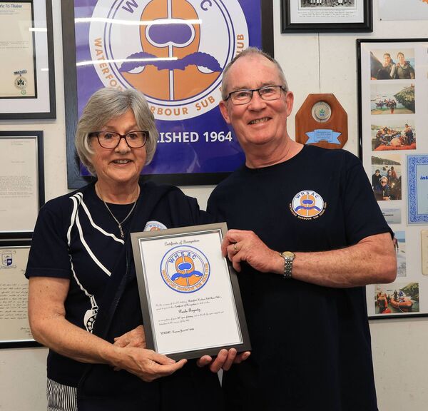 Mick Leavy, Chairperson, presenting a certificate to Paula Fogarty in recognition of her 50th year diving. Mick Leavy, Chairperson, presenting a certificate to Paula Fogarty in recognition of her 50th year diving.