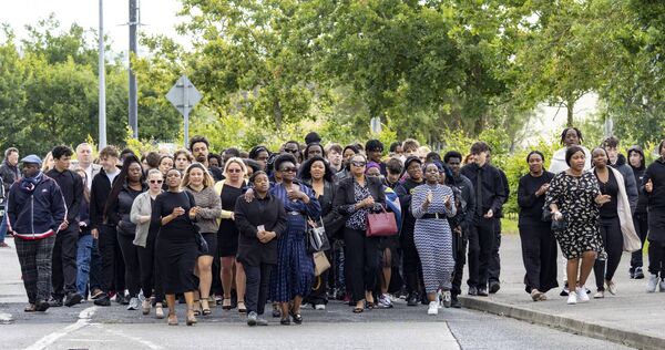 Mourners walk behind the funeral cortege for Avu Idris as it makes its way to Kilbarry Cemetery. 