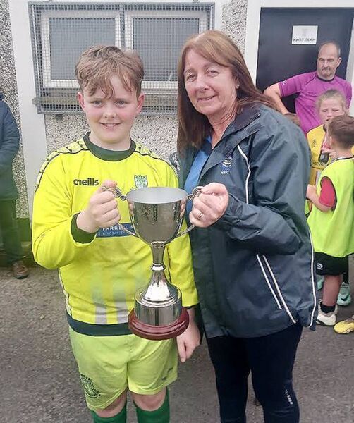 Villa FC captain Ewan Power receives the WSFL Under 11H Cup from Mary Ray, who the cup is named after.