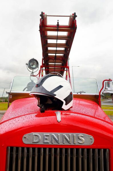The funeral cortege of former fire fighter Con Malone stopped off at Waterford Fire Station where former colleagues paid their respects and placed Con's helmet on the old Dennis fire engine. Photo: Joe Evans