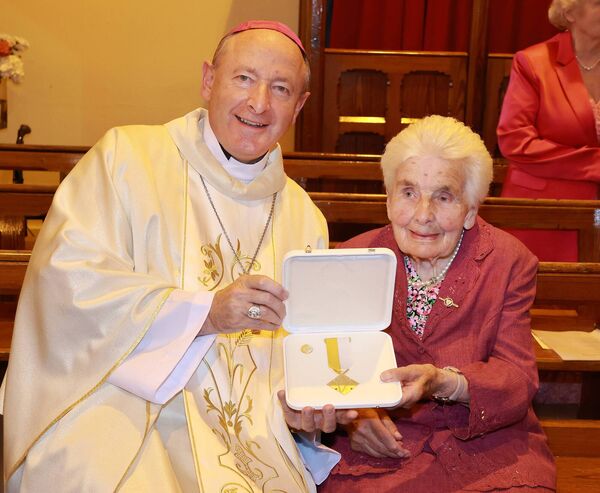 Bishop Alphonsus Cullinan presented Mary Power with the Papal award the Benemerenti Medal at a Mass of Thanksgiving, at the sacred Heart Church, Dunhill in recognition of Mary's 48 years service to the church. Photo: Joe Evans
