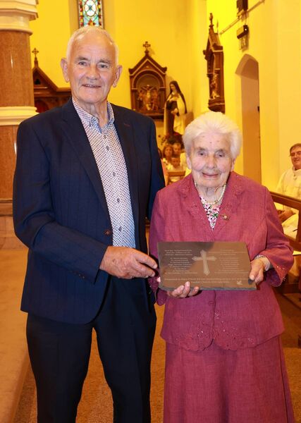 john queally presented a special plaque on behalf of the parish Mary Power who received the Papal award the Benemerenti Medal at a Mass of Thanksgiving, at the sacred Heart Church, Dunhill in recognition of Mary's 48 years service to the church. Photo: Joe Evans
