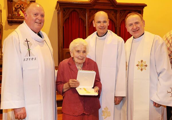 Fr. Mark, Fr. Richard and Fr. Tadusz with Mary Power who received the Papal award the Benemerenti Medal at a Mass of Thanksgiving, at the sacred Heart Church, Dunhill in recognition of Mary's 48 years service to the church. Photo: Joe Evans