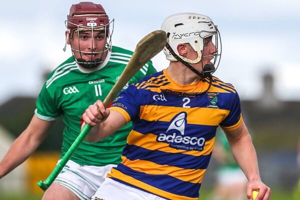 Abbeyside's Seán Whelan Barrett gets away from Ferrybank's Ruaidhri McGarrity