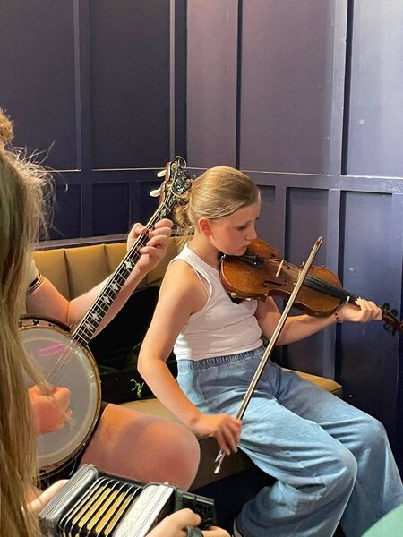 Issie McCabe, daughter of Kieran and Sarah McCabe, one of the younger members of the club who sat in on a session with her fiddle between dances