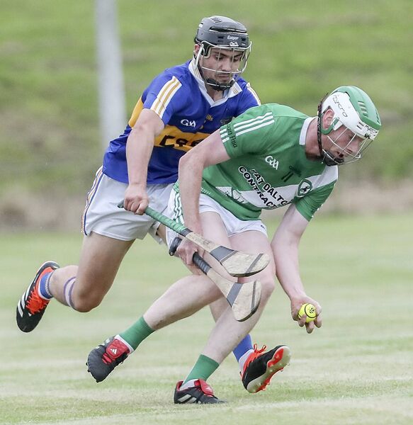 Clonea's Michael Curry with the sliothar ahead of Tallow's Robbie Geary.