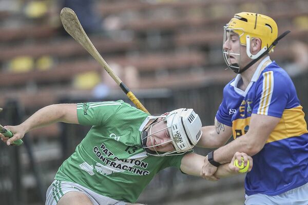 Clonea's Francis Roche under pressure from Tallow's Ben Aherne during their J.J.Kavanagh &amp; Sons Waterford senior hurling match in Fraher Field. 