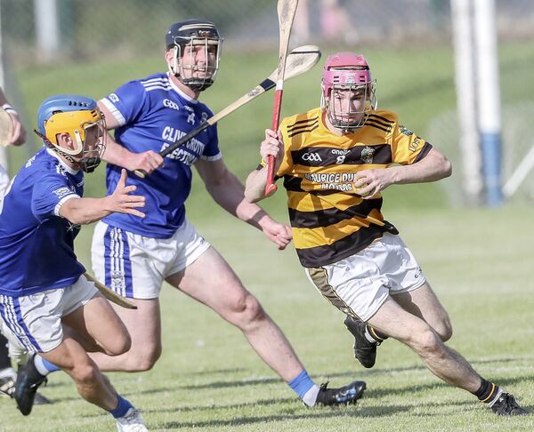 Lismore's Joseph O’Keeffe in possession against Dungarvan's Eddie Burke and Patrick Curran during their J.J.Kavanagh &amp; Sons Waterford Senior hurling championship match in Fraher Field. 
