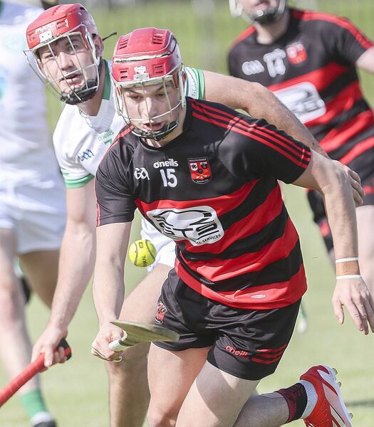 Ballygunner's Jake Foley with the sliothar ahead of Shamrock's Billy Hynes.