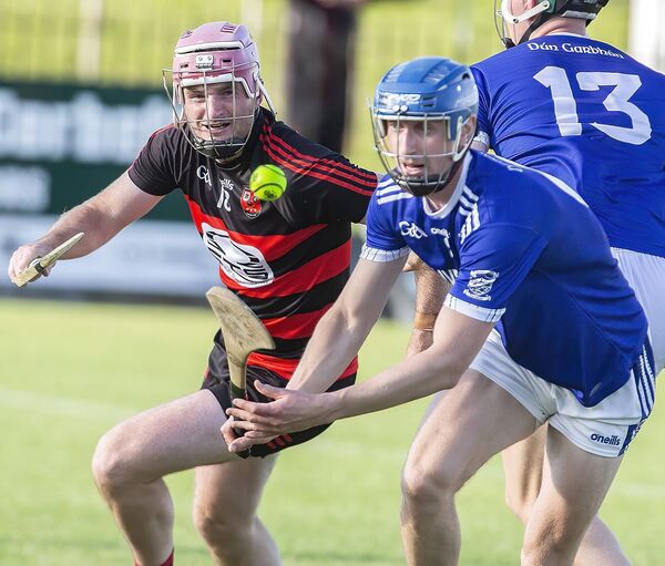 Dungarvan's Jack Lacey controls the sliothar against Ballygunner's Billy O'Keeffe. Dungarvan's Jack Lacey controls the sliothar against Ballygunner's Billy O'Keeffe.