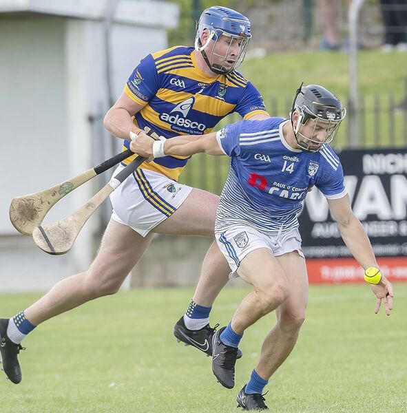 Fourmilewater's Jamie Barron about to gain possession against Abbeyside's Conor Prunty.