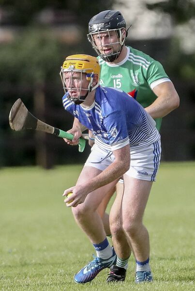 Fourmilewater's Evan Spellman in possession against Ferrybank's Neil O’Sullivan. 