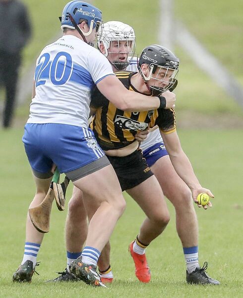 Brickeys' Sean Lennon is tackled by Tramore's Darren Cody and Dan Morrissey. 