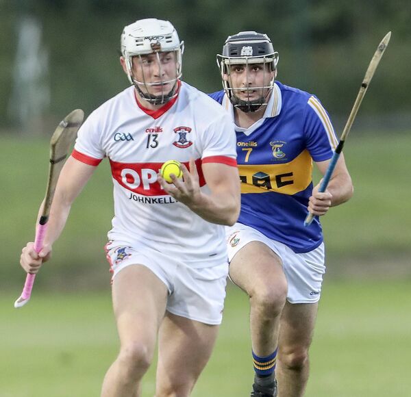 De La Salle's Reuben Halloran with the sliothar ahead of Tallow's Eoin McGrath. 