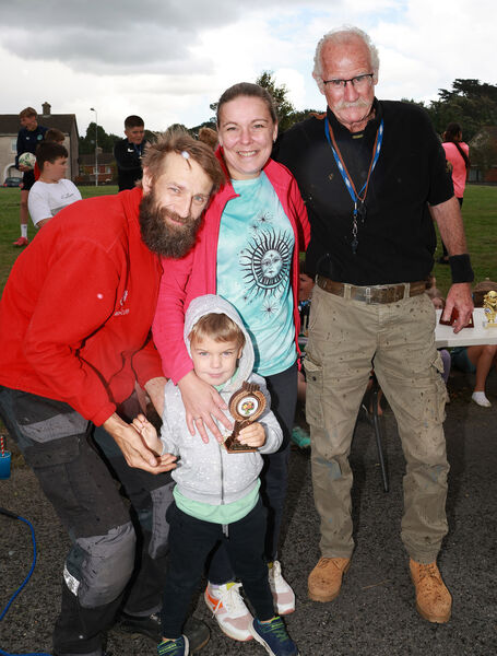  Jim O'Sullivan, Chairman, presenting the best small garden trophy to the Sveikauskas family.