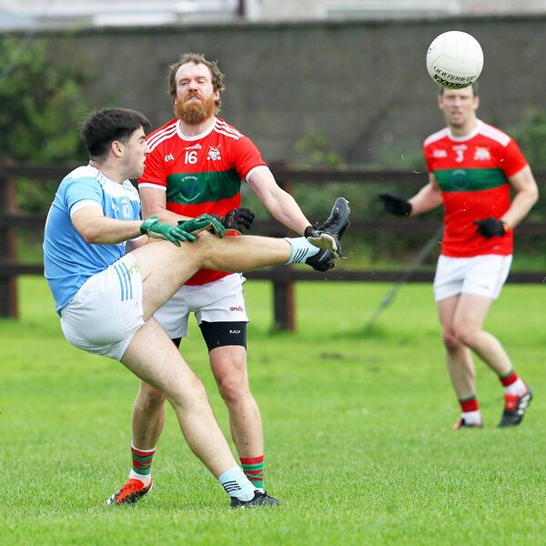 Roanmores Sam Pender gets his shot away despite the challenge from Clashmore/Kinsalebeg's Cillian O'Keeffe.