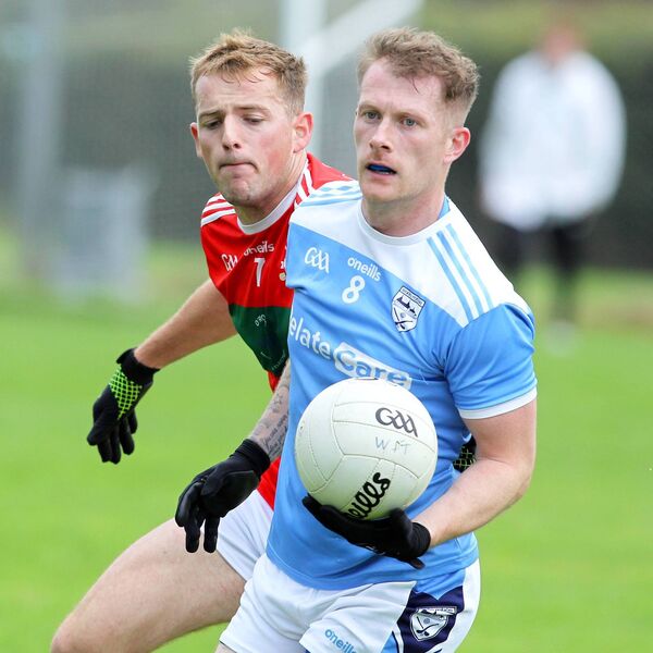 Roanmores Dean Reidy has Clashmore/Kinsalebeg's Cian Ryan closing in during their senior football battle. 