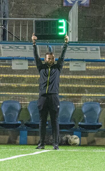Waterford's Ian O'Keeffe holds the board to indicate three minutes of added time in the first-half of Cobh Ramblers and Wexford. Waterford's Ian O'Keeffe holds the board to indicate three minutes of added time in the first-half of Cobh Ramblers and Wexford.