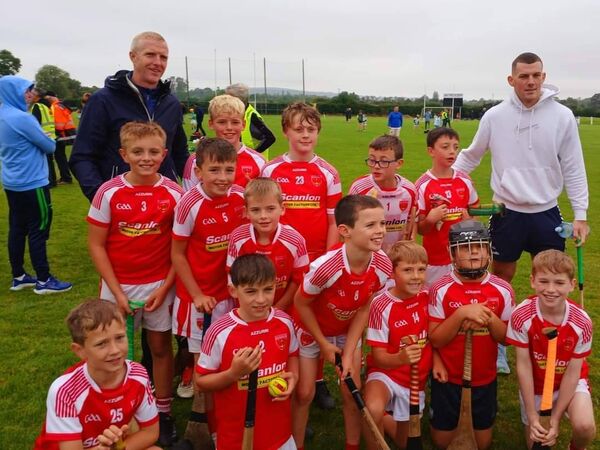 Passage U10 team with former hurling legend, Henry Shefflin (left) and current Kilkenny hurler, Eoin Coady