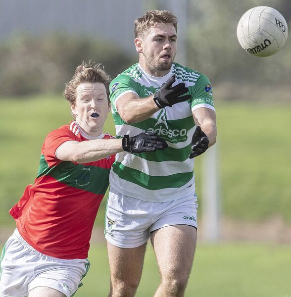 Ballinacourty's Brian Looby hand passes under pressure from Clashmoire/Kinsalebeg's Aidan Trihy. Ballinacourty's Brian Looby hand passes under pressure from Clashmoire/Kinsalebeg's Aidan Trihy.