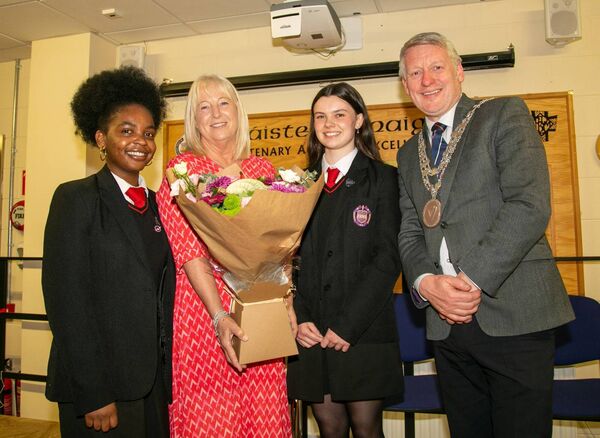 Bouquet presentation to Principal Orla Bolger to mark her last awards ceremony before retirement. From left: Angie Goma (Head Girl), Orla Bolger (Principal), Holly Power (Deputy Head Girl), Mayor Cllr Jason Murphy.