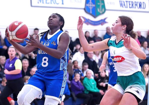 Wildcats Alshia McCalla about to score as Liffey Celtics Ciara Bracken closes in.