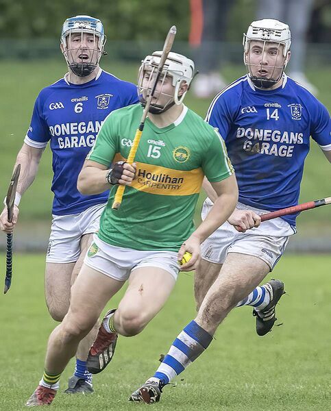 Kilrossanty's Padraig Fitzgerald gets ahead of Feenagh Kilmeedy's Byran Hannigan and Ruairi Hannigan.