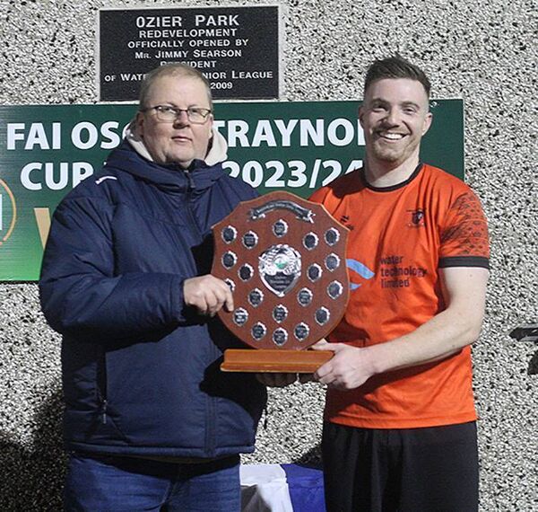 Southend United captain Dan O'Connell receiving the Azzurri Division 2 League trophy from Ger Murphy, secretary of the Waterford Junior League.