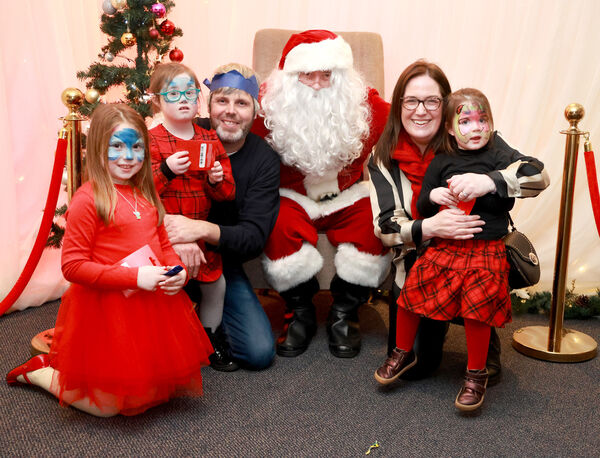  The Keogh family with Santa, at the Down Syndrome Christmas Party in the Tower Hotel. Photo: Joe Evans