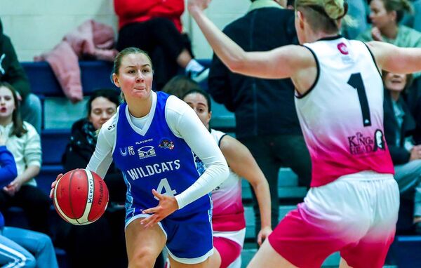 Wildcats Orla Dullegham try to get around Mystic's Lisa Burke
