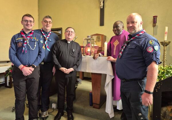 The Peace Light from Bethlehem, with members of De La Salle Scouts and Fr. Conor Kelly and Fr. Philip of Mountstuart. Photo: Joe Evans
