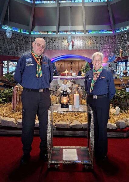The Peace Light from Bethlehem, at the Sacred Heart Church, with Brian and Bernie, Scared Heart Scout Unit. Photo: Joe Evans