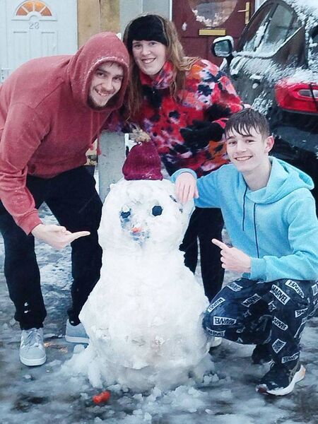 Sean Cox, Jodie Fagan and Jamie Fagan, with their snowman at Templars Hall.