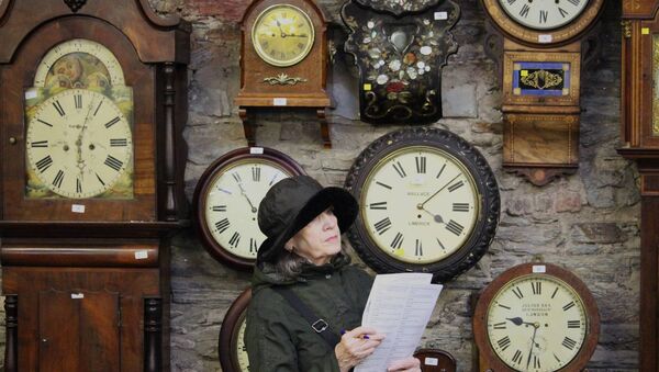 An attendee at Ireland's largest ever clock auction weighs up her options of making a bid. Photo by Hugh Dooley. An attendee at Ireland's largest ever clock auction weighs up her options of making a bid. Photo by Hugh Dooley.