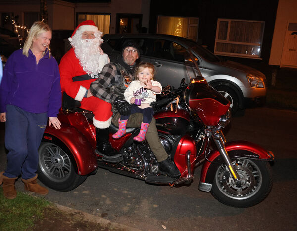  Ann and Amelia with Santa, who enlisted the help of Celtic Thunder Chapter Ireland to help deliver pre-Christmas presents to the children at Hillview estate.